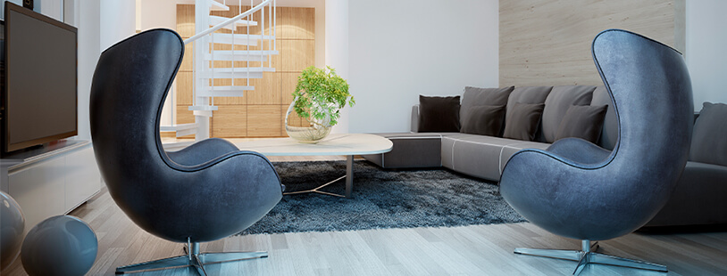Comtemporary interior with grey and blue grey hues showcasing two light blue velvet Egg Chairs